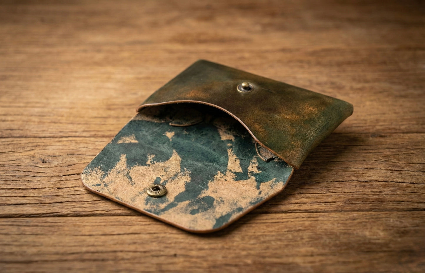 Shell Cordovan Stitchless handmade leather wallet showing marbled green leather surface.