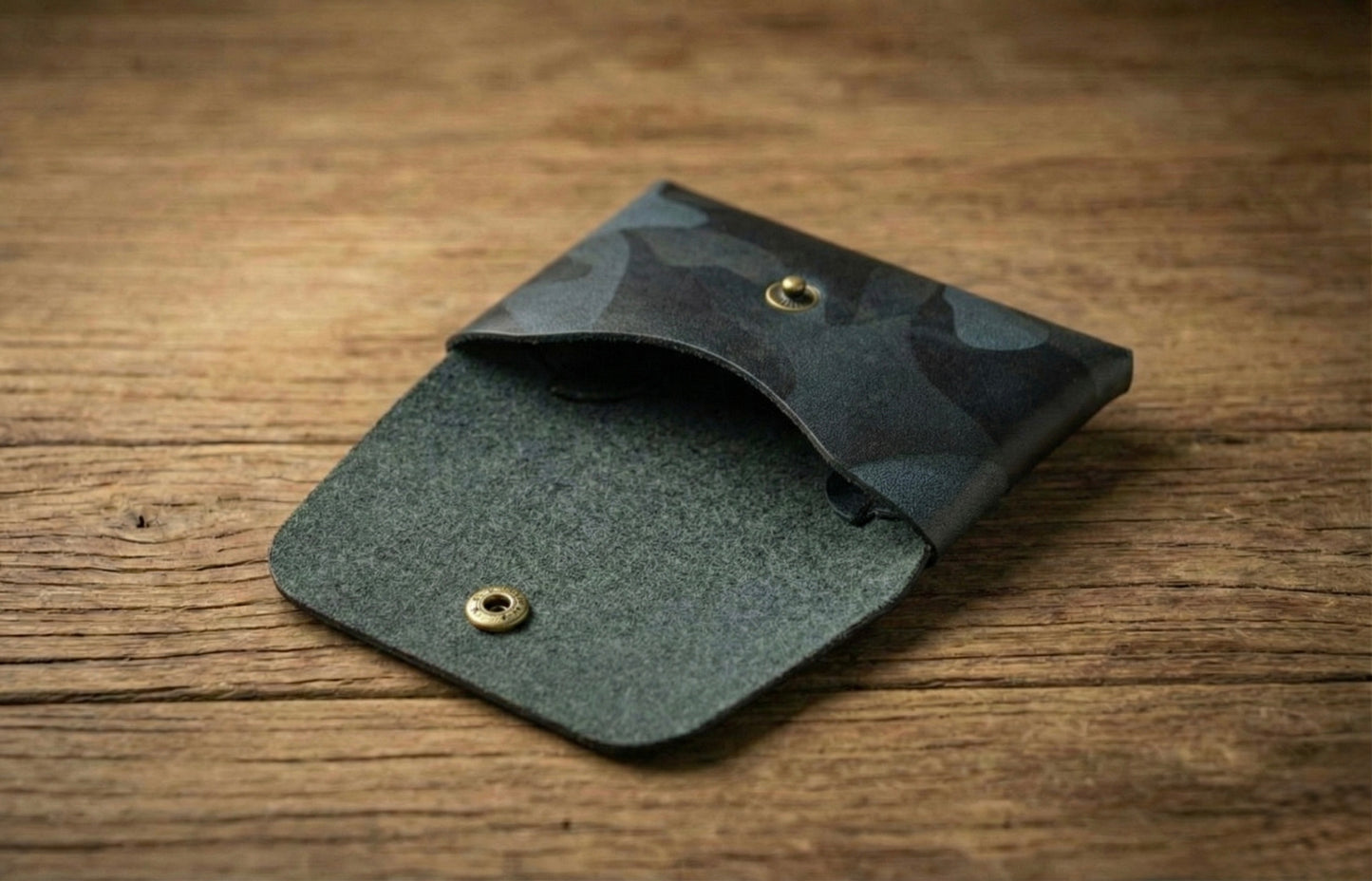 Stitchless Handmade Leather Wallet - EDC Leather Wallet in black camo design resting on a wooden surface.